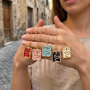 Detailed macro view of five colorful tarot-inspired snake pendants with zircon crystals