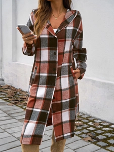 Plaid hooded coat in brown and grey styled with buttons on an outdoor model