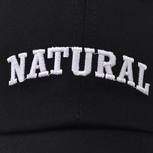 Front view of black cotton baseball cap with white 3D embroidered NATURAL lettering