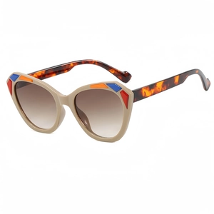 Fashionable cat-eye sunglasses with beige frames and tortoiseshell temples shown in 45-degree angle