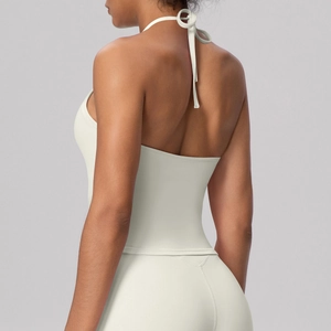 Detail of the backless halter yoga top showing high-quality cream fabric and straps