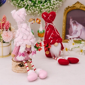 Detail of plush gnome dolls with sequined hats and long legs made of faux pearl beads
