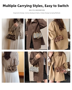 Detail showing multiple back methods of the leopard print box bag with pearl clasp