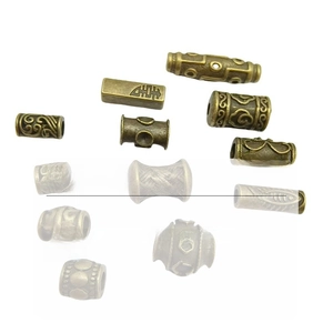 Detail of vintage bronze spacer beads with intricate hollow patterns for DIY jewelry