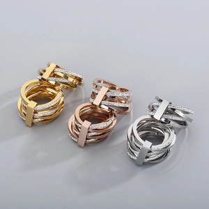 Detailed view of layered rhinestone rings in gold, rose gold and silver finishes