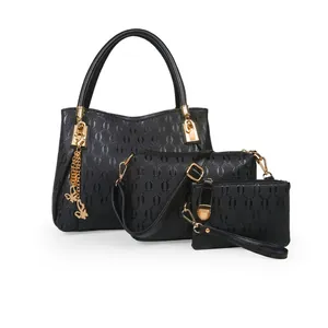 Three-piece set featuring black embossed tote bag, crossbody bag, and small clutch with gold hardware