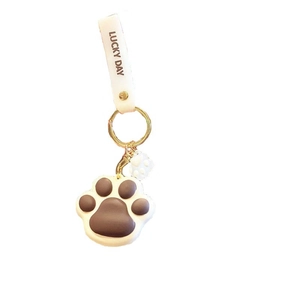 Cute cartoon cat paw PVC keychain in brown and cream with Lucky Day strap