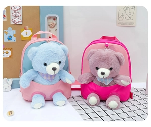 Close-up of cute plush bear backpacks in pink and fuchsia colors for children