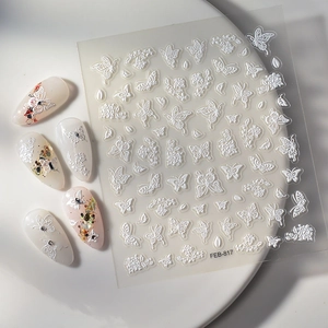 Detail of 5D white embossed butterfly and flower nail stickers with 3D relief texture