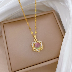 Luxurious gold flower pendant necklace with color-changing stone and sparkling diamonds
