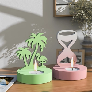 Artistic shadow play on geometric candle holders with palm tree and hourglass designs