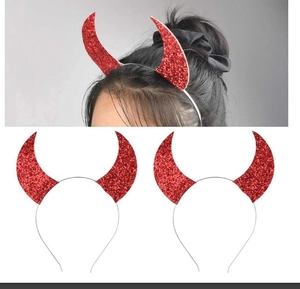 Close-up of red sequined devil horn headband with silver metal base for Halloween