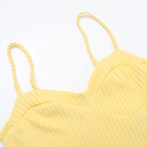 Detail of yellow knit tank top featuring a sweetheart neckline and braided shoulder straps