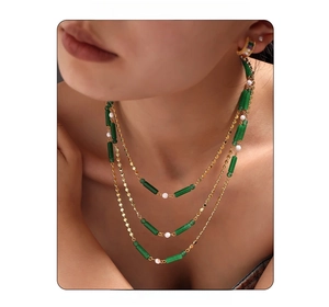 Vue détaillée du collier doré multicouche avec aventurine verte et perles blanches