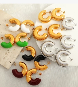 Detailed close-up of C-shape hoop earrings in assorted colors and textured finishes