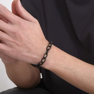 Close-up of matte black stainless steel O-chain bracelet on a male model's wrist