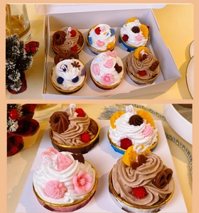 Set of 6 realistic cupcake scented candles in a gift box with various dessert designs