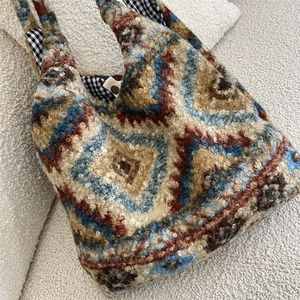 Detail of plush tote bag showing geometric pattern, gingham lining, and metal snap button