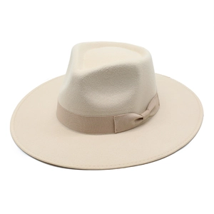 Detail of wool fedora hat with elegant grosgrain ribbon bow on the beige brim