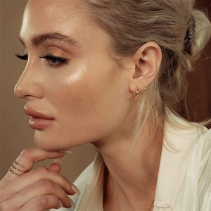 Spiral twisted double hoop earrings in gold plated stainless steel worn by a model