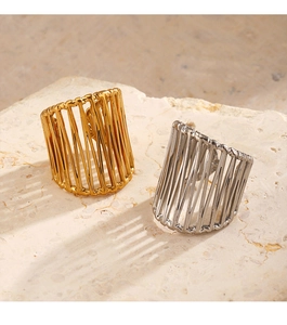 Detailed view of chunky 18K gold and silver plated hollow lined rings on stone