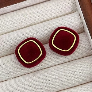 Red velvet square earrings with gold frame in a jewelry box for a festive look