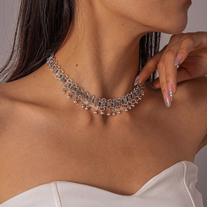 Detail of vintage silver boho choker featuring intricate cutout patterns and bead charms