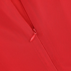 Close-up of red elegant evening dress featuring a hidden zipper and woven fabric texture