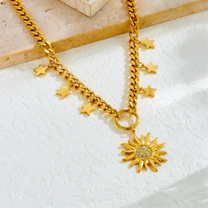 Chunky gold chain necklace with star charms and sparkling rhinestone sun pendant