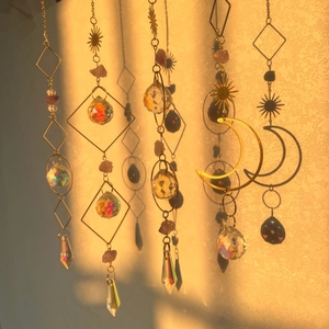 Detail of four golden crystal suncatchers casting beautiful light and shadow on the wall
