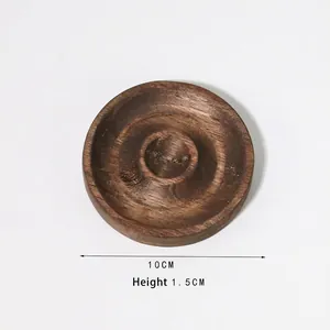 Detail view of a 10cm round dark wood display tray with a 1.5cm thickness for jewelry