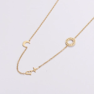 French style gold necklace with crescent moon, heart, and Greek key pattern pendants
