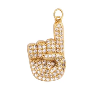 Detail view of gold-plated hand charm with zircon inlay including 19mm x 12mm dimensions