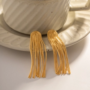 Minimalist gold tassel earrings in titanium steel hanging on a ceramic coffee cup