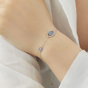 Bracelet œil bleu en argent sterling S925 avec zircons sur fond de tissu blanc