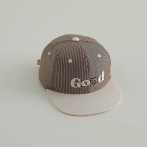 Detail of children's striped baseball cap featuring a cute bear embroidery and 'Good' text