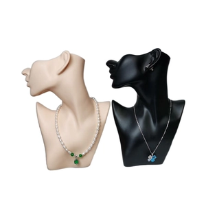 Dual PVC jewelry neck mannequins in black and flesh tones showcasing pearl necklaces