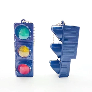 Detail view of mini traffic light keychain with LED light effect and golden bead chain