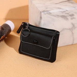 Slim black leather coin purse with zipper and silver keyring on a neutral background