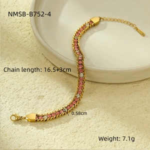 Macro view of gold chain bracelet with pink and white zircon stones on a tray
