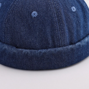 Close-up of deep blue denim miki hat showing thick cotton texture and neat stitching