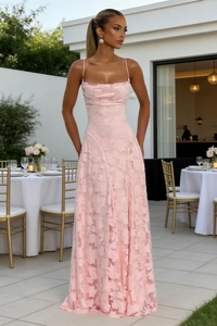 Detailed texture of pink floral lace fabric on elegant slim strap long dress