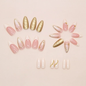 Detail of 24pcs press-on nails featuring French tips, 3D gold spirals, and pearl accents