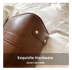 Detailed macro view of high-quality brown leather texture and gold metal rivet hardware