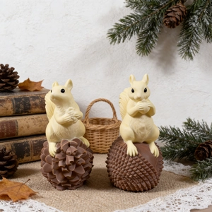 Artistic squirrel candle on pinecone base with detailed texture for autumn decor