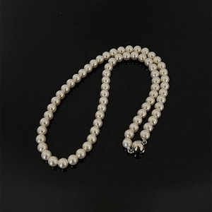 Classic single strand white pearl necklace with a silver metallic spherical clasp