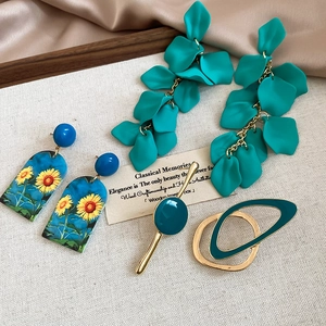 Detail view of sunflower painted drop earrings and vintage blue floral jewelry set