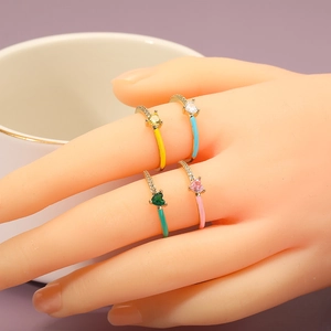 Four colorful enamel heart rings with cubic zirconia on a gold plated adjustable band