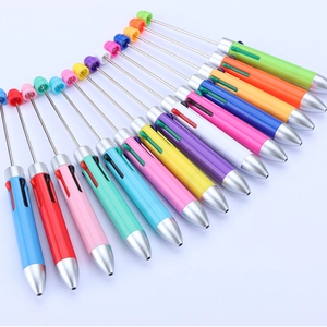 Detail of colorful retractable beaded pens in a fan layout showing multiple color options
