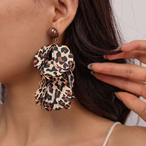 Close-up of leopard print chiffon petal tassel earrings on a model for autumn style